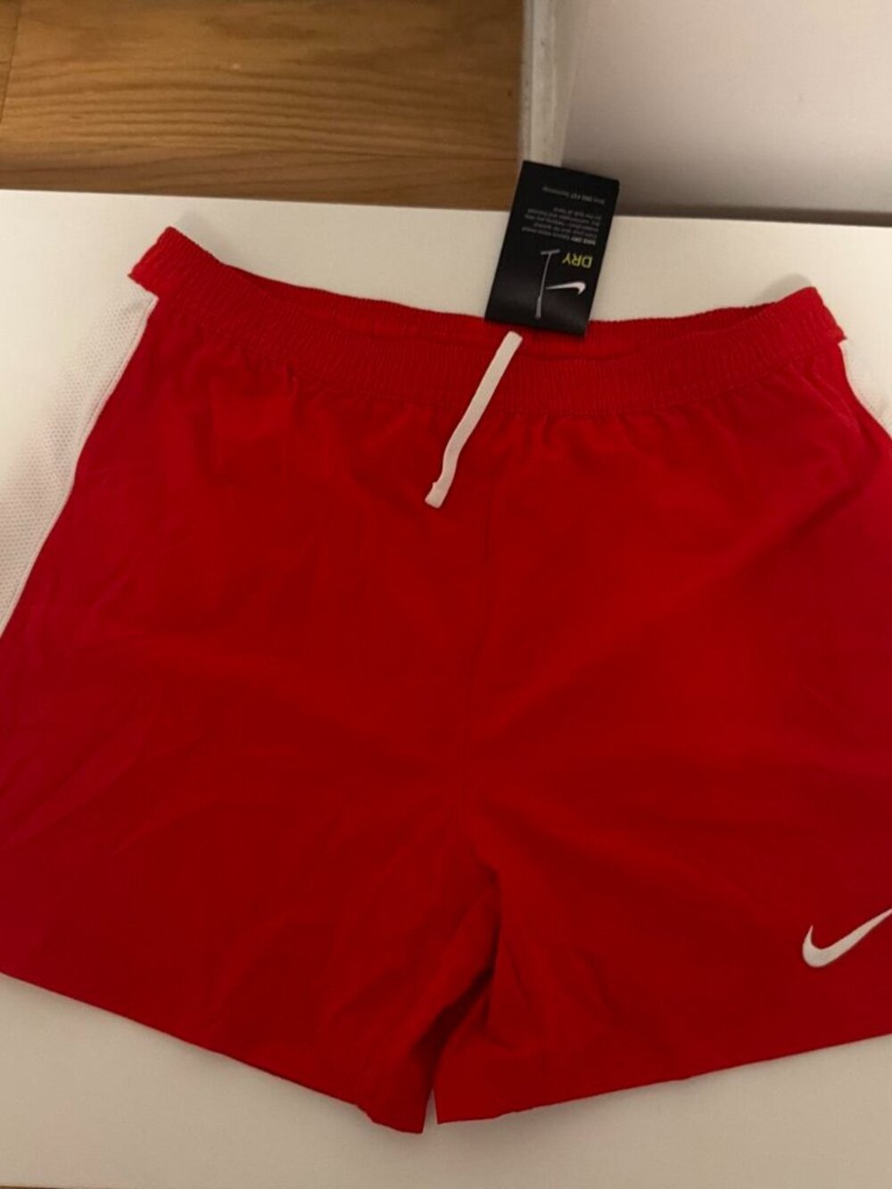 Nike red shorts with white side panels